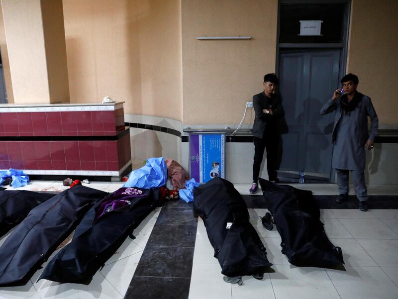 Afghan men look for their relatives at a hospital after a suicide bombing in Kabul, Afghanistan.  Reuters