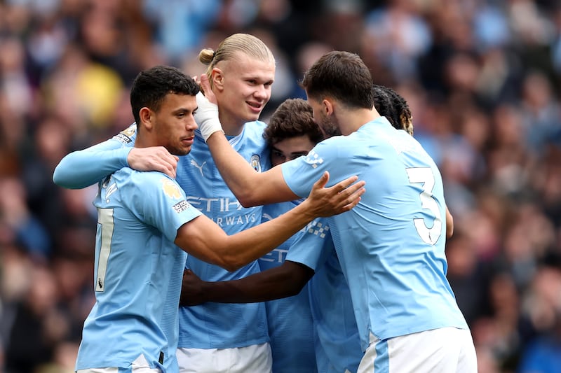 Erling Haaland of Manchester City celebrates with teammates after his shot was defected in for the first goal in the 5-1 Premier League win against Luton Town at the Etihad Stadium on Saturday, April 13, 2024. Getty Images