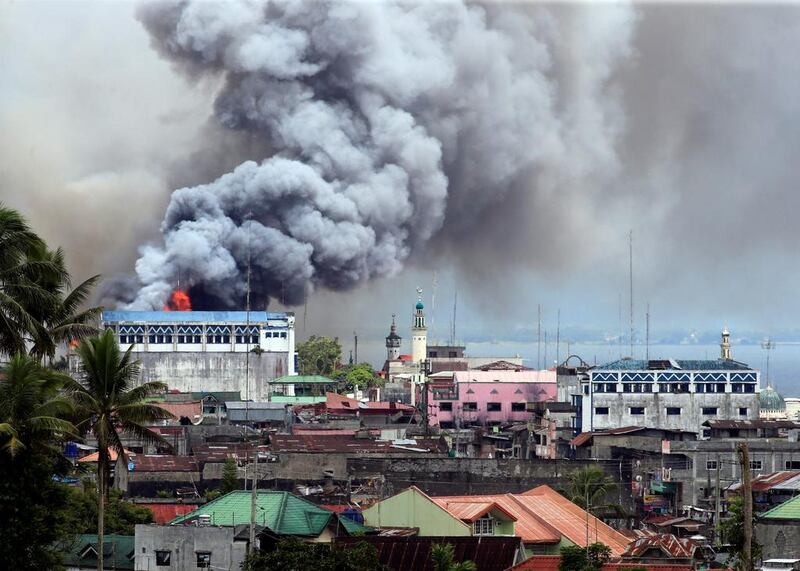 Black smoke comes from a burning building in a commercial area of Osmena street in Marawi city, Philippines. Romeo Ranoco / Reuters