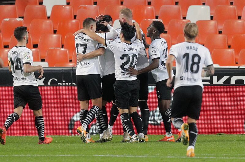 Valencia's midfielder Carlos Soler (3-L) celebrates with teammates after levelling the scores. EPA