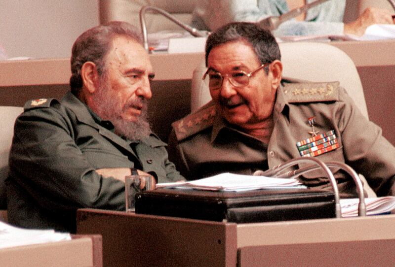 392855 03: Cuban President Fidel Castro, left, and his brother Raul Castro, speak to each other August 3, 2001 during a session of the National Assembly legislature in Havana. The parliament condemned U.S. President George W. Bush''s "cruel" policies on Cuba, and called for the release of five Cuban agents jailed in Miami on spy-related charges. (Photo by Jorge Rey/Getty Images)