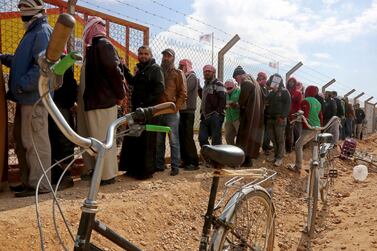 Syrian refugees line up to register their names at an employment office at the Azraq refugee camp, 100 kilometres east of Amman, Jordan. AP