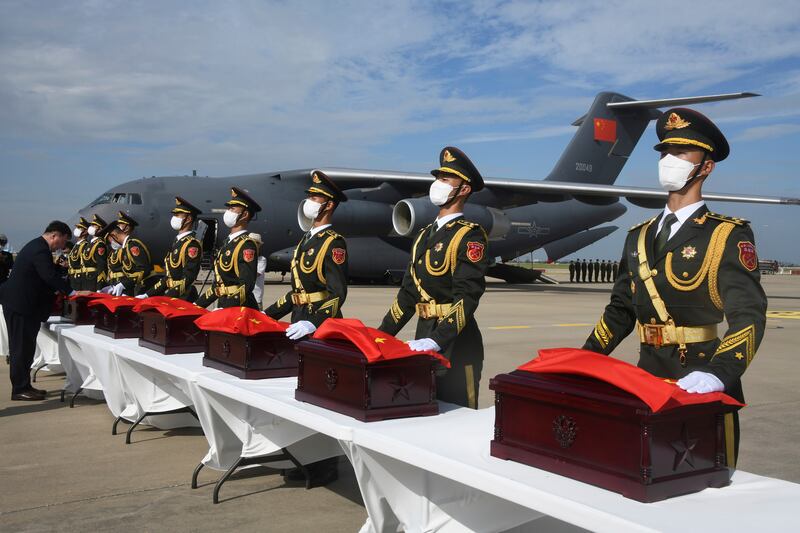 Chinese soldiers with caskets containing the remains of Chinese soldiers who were killed in the 1950-1953 Korean War during the handing over ceremony at Incheon International Airport in South Korea. AP