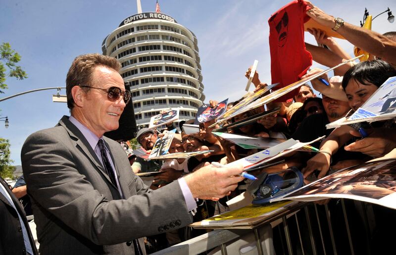 Bryan Cranston, star of the television series "Breaking Bad," signs autographs after receiving a star on the Hollywood Walk of Fame on Tuesday, July 16, 2013 in Los Angeles. (Photo by Chris Pizzello/Invision/AP) *** Local Caption ***  Bryan Cranston Honored with a Star on the Hollywood Walk of Fame.JPEG-03333.jpg
