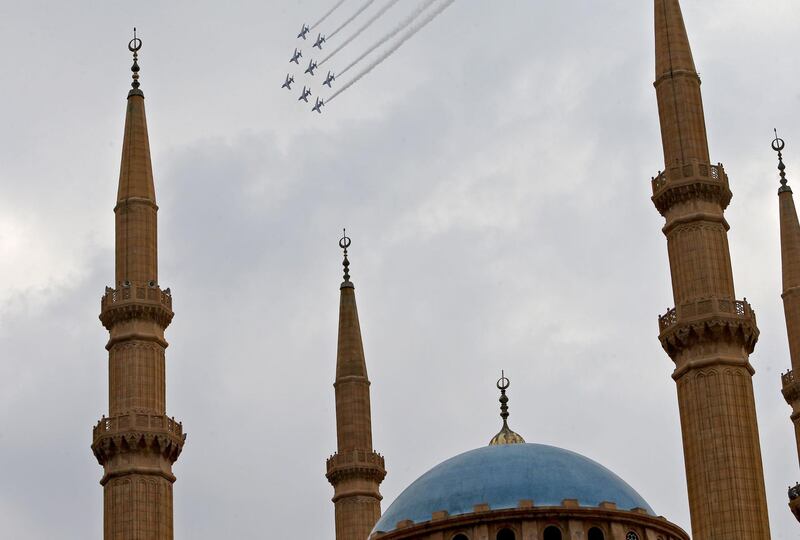 Alpha jets of the Patrouille de France release smoke in the colours of the Lebanese flag while flying over the Mohammad al-Amin mosque in the centre of Lebanon's capital Beirut, as the former French mandate marked its centenary while teetering on the brink of the abyss.   AFP