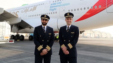 Capt Philippe Lombet, right, and Capt Khalid bin Sultan prepare to fly an Emirates A380 jet powered by sustainable aviation fuel in one engine. Chris Whiteoak / The National