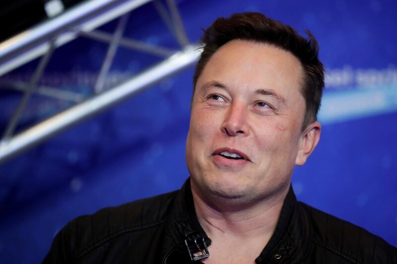 FILE - In this Tuesday, Dec. 1, 2020, file photo, SpaceX owner and Tesla CEO Elon Musk arrives on the red carpet for the Axel Springer media award, in Berlin. In a tweet Tuesday, Dec. 22, 2020, Musk said he once considered selling the electric car maker to Apple, but the iPhone makerâ€™s CEO Tim Cook blew off the meeting. (Hannibal Hanschke/Pool Photo via AP, File)