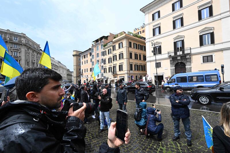 Italian police officers stand guard as Mr Zelenskyy is driven through Piazza Barberini. AFP