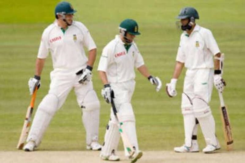 Three at the crease: South Africa captain Graeme Smith, left, talks to Neil McKenzie and Hashim Amla, right, while acting as McKenzie's runner during the first Test match at Lord's.