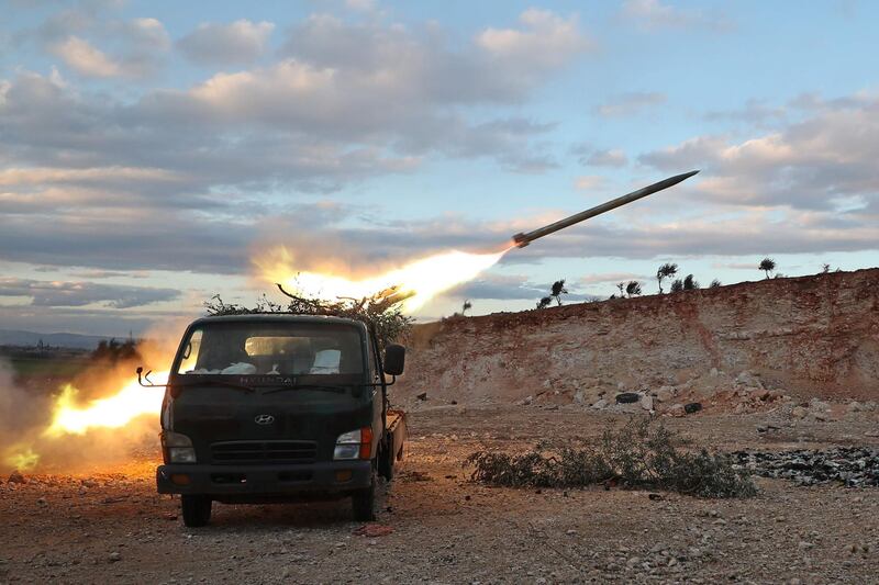 Syrian rebel fighters fire a Grad rocket towards government forces in northwestern Syria.  AFP