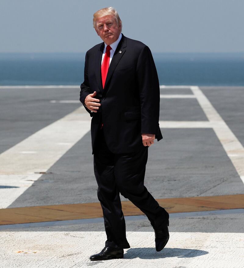 As Ships Captain Rick McCormack salutes at right, President Donald Trump walks to board Marine One on the flight deck of the USS Gerald R. Ford (CVN 78) at Naval Station Norfolk, Va., Saturday, July, 22, 2017, after the commissioning ceremony of the aircraft carrier. (AP Photo/Carolyn Kaster)