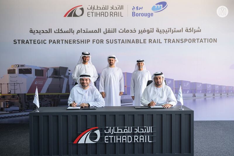 Standing from left, Dr Sultan Al Jaber, Minister of Industry and Advanced Technology; Sheikh Theyab bin Mohamed, member of the Abu Dhabi Executive Council; and Suhail Al Mazrouei, Minister of Energy and Infrastructure, attend the signing ceremony. The agreement was signed by Shadi Malak, chief executive of Etihad Rail, left, and Hazeem Al Suwaidi, chief executive of Borouge. Photo: Abu Dhabi Government Media Office