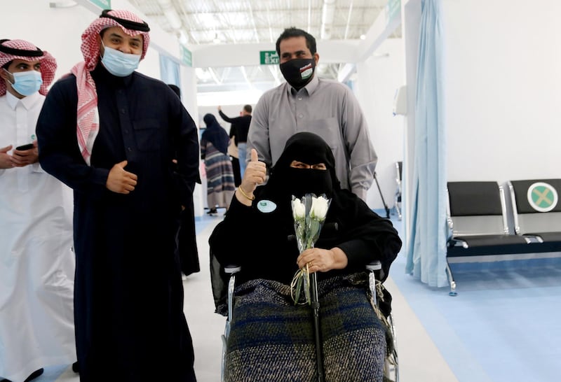 A Saudi woman gestures after she received the first dose of a coronavirus disease (COVID-19) vaccine, in Riyadh, Saudi Arabia December 17, 2020. REUTERS/Ahmed Yosri