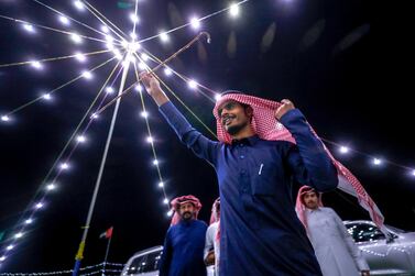 Ali Al Qahtani celebrates the victory of a two year old camel at the Al Dhafra Festival in Abu Dhabi, UAE. Victor Besa / The National