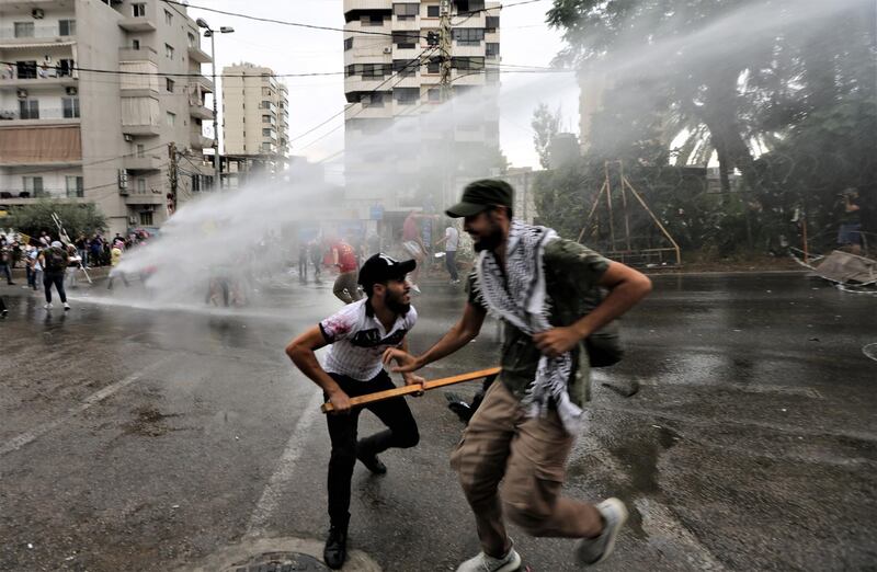 Protesters face water cannon from riot police during a demonstration organised by supporters of Hezbollah, Lebanese communist party, and other Lebanese national parties at the US embassy against US interference in Lebanon's affairs, in Awkar area north-east Beirut, Lebanon. EPA