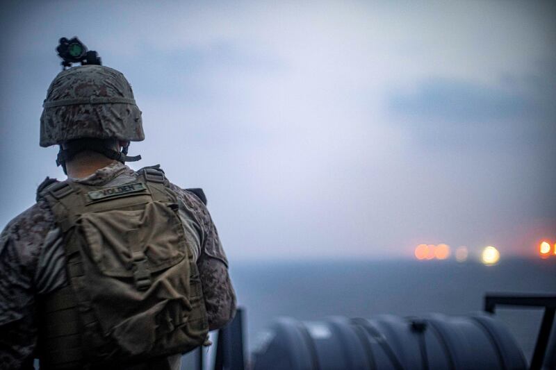 Marines onboard the amphibious transport dock ship USS John P. Murtha (LPD 26) observe near by vessels as it transits the Strait of Hormuz, off Oman, in this undated handout picture released by U.S. Navy on August 12, 2019. Adam Dublinske/U.S. Navy/Handout via REUTERS ATTENTION EDITORS- THIS IMAGE HAS BEEN SUPPLIED BY A THIRD PARTY.