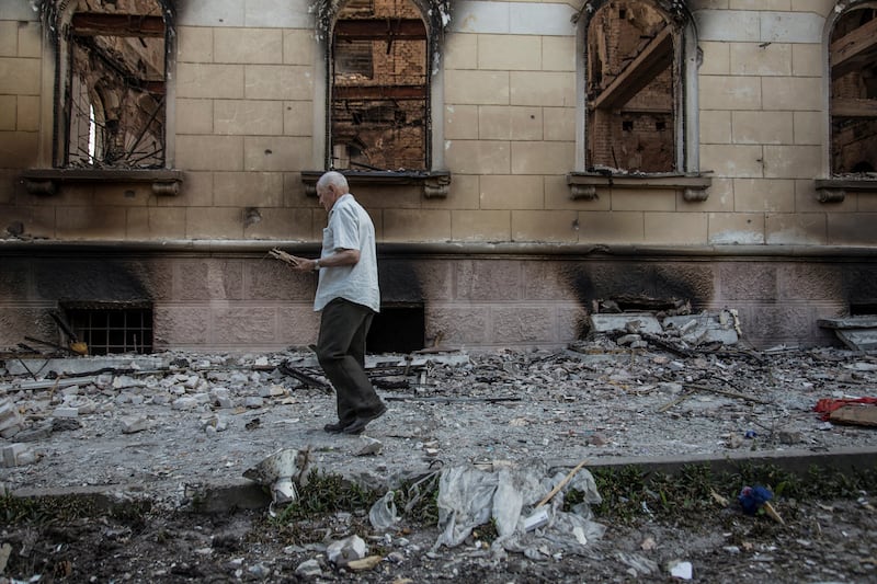 A man walks next to a damaged building in Lysychansk. Reuters