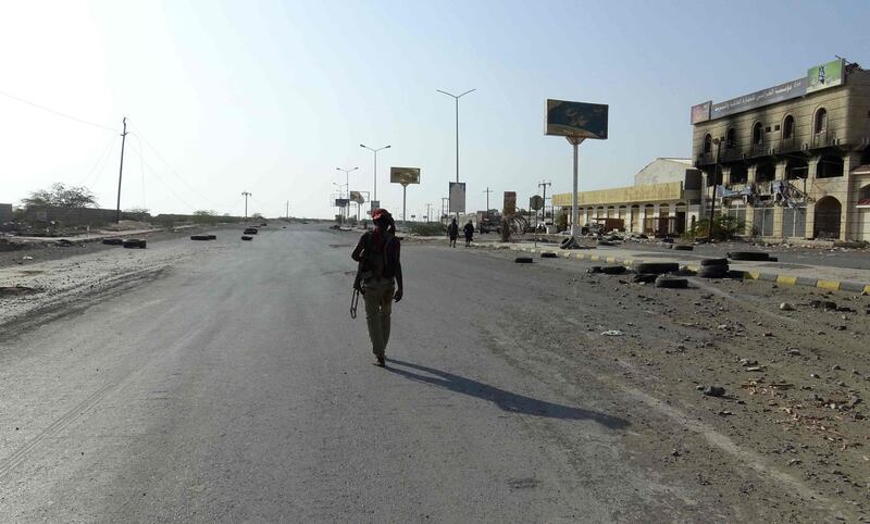 A Yemeni fighter from the pro-government forces walks in the Houthi-held Red Sea port city of Hodeida. AFP