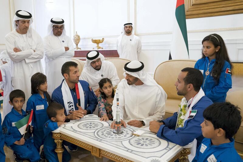 ABU DHABI, UNITED ARAB EMIRATES - October 12, 2019: HH Sheikh Mohamed bin Zayed Al Nahyan, Crown Prince of Abu Dhabi and Deputy Supreme Commander of the UAE Armed Forces (C), speaks with Sultan Saif Al Neyadi, a member of the International Space Station (ISS) mission back-up team (L) and Hazza Ali Al Mansoori, the first UAE Astronaut to be deployed on a space mission to the International Space Station (ISS) (R) , during a homecoming reception at the Presidential Airport. 
Seen with HH Sheikh Hazza bin Zayed Al Nahyan, Vice Chairman of the Abu Dhabi Executive Council (back L). 

( Mohamed Al Hammadi / Ministry of Presidential Affairs )
---