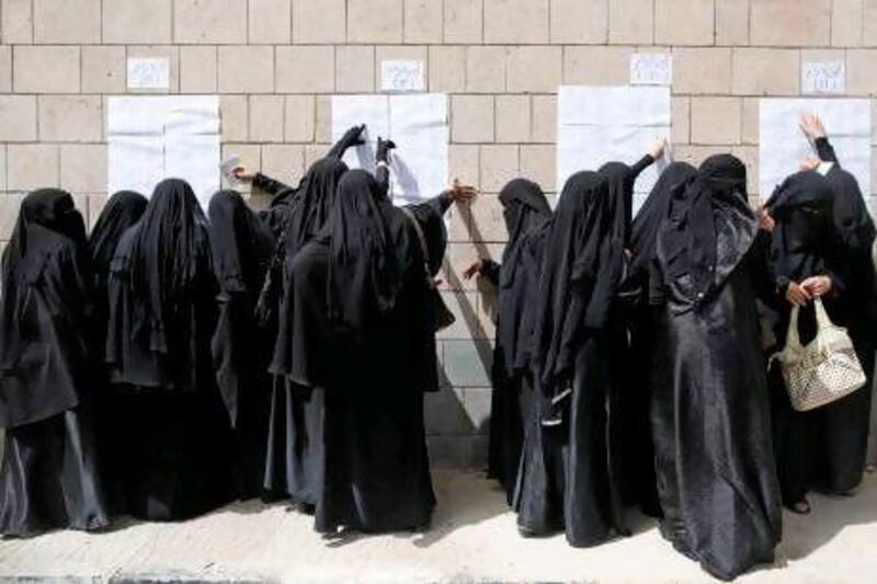 Female voters check voting rolls in the Al Hasaba neighbourhood of Sanaa yesterday.