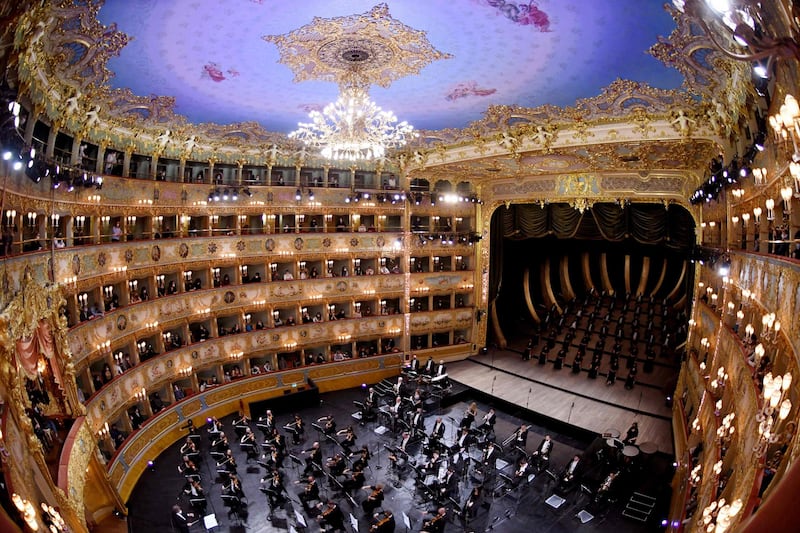 This photograph taken with a fish-eye effect shows musicians and chorus of the Fenice Opera theatre perform the “Verdi e la Fenice” ( Verdi and the Fenice ) to mark the reopening of the Fenice Opera theater in Venice as bars, restaurants, cinemas and concert halls partially reopen across Italy in a boost for coronavirus-hit businesses, as parliament debates the government's 220-billion-euro ($266-billion) EU-funded recovery plan. After months of stop-start restrictions imposed to manage its second and third waves of Covid-19, Italy hopes this latest easing will mark the start of something like a normal summer. AFP
