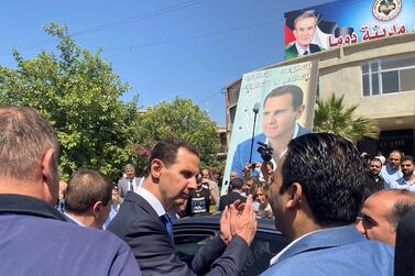 Syria's President Bashar Al Assad gestures as he leaves a polling station after he cast his vote, during the country's presidential elections in Douma, Syria. Reuters