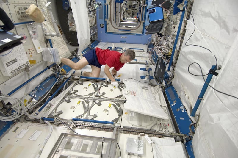 Canadian Space Agency astronaut Robert Thirsk, Expedition 20 flight engineer, inserts urine samples into the ISS Laboratory Freezer  as part of the Nutritional Status Assessment study. Wikicommons