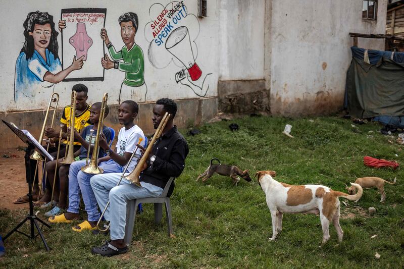 Members of a community brass band take a break from rehearsals for a performance in Bwaise, Kampala, Uganda. AFP