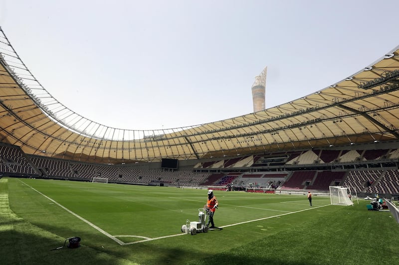 A picture taken on May 18, 2017, shows labourers working at the Khalifa International Stadium in Doha after it was refurbished ahead of the Qatar 2022 FIFA World Cup.
Up to 1.3 million fans will visit Qatar during the 2022 World Cup, according to Nasser Al-Khater, a senior figure with the body organising Qatar's World Cup, a figure equivalent to half the Gulf country's current population. / AFP PHOTO / KARIM JAAFAR