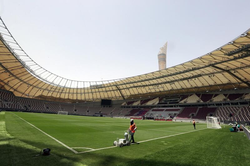 A picture taken on May 18, 2017, shows labourers working at the Khalifa International Stadium in Doha after it was refurbished ahead of the Qatar 2022 FIFA World Cup.
Up to 1.3 million fans will visit Qatar during the 2022 World Cup, according to Nasser Al-Khater, a senior figure with the body organising Qatar's World Cup, a figure equivalent to half the Gulf country's current population. / AFP PHOTO / KARIM JAAFAR