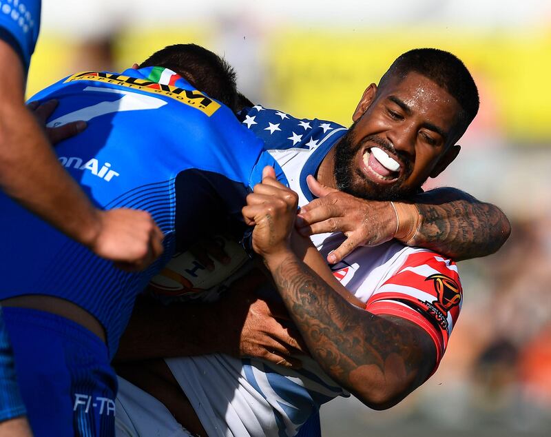 Eddy Pettybourne of the USA is tackled by Ryan Ghietti of Italy during the 2017 Rugby League World Cup match between Italy and the USA at 1300SMILES Stadium in Townsville, Australia. Ian Hitchcock / Getty Images