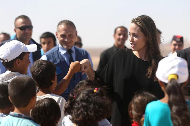 US actress and UNHCR special envoy and goodwill ambassador Angelina Jolie greets children during a press conference at Al Azraq camp for Syrian refugees in Azraq, Jordan. Jordan Pix / Getty Images