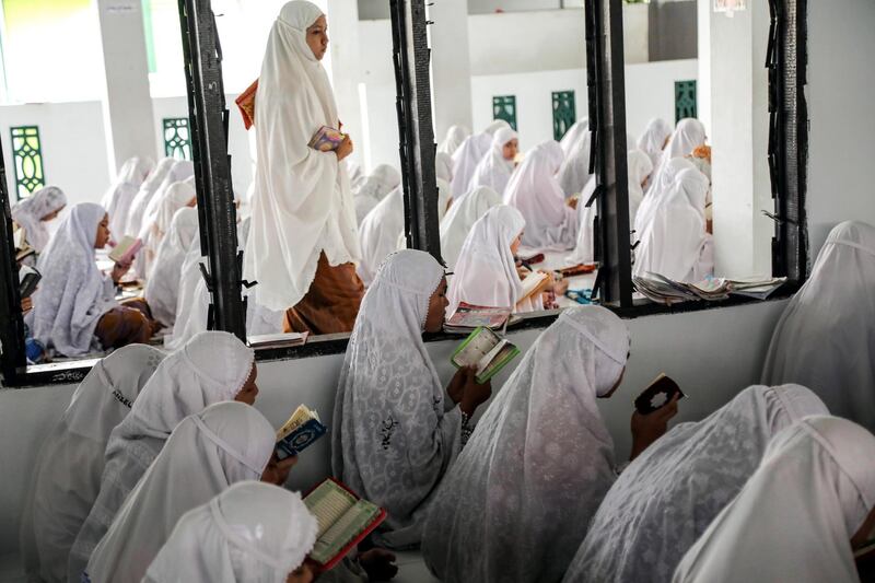 Students read the holy Quran on the first day of Ramadan at Ar-Raudhatul Hasanah Islamic boarding school in Medan, North Sumatra, Indonesia, on May 17, 2018. Dedi Sinuhaji / EPA