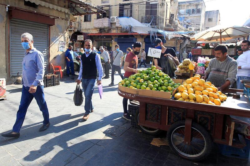 People walk at a souk, as the Lebanese government ordered a national lockdown, to combat a resurgence of the coronavirus disease (COVID-19) outbreak, in Sidon, Lebanon November 16, 2020. Picture taken November 16, 2020. REUTERS/Aziz Taher