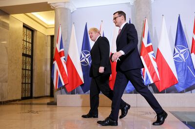 British Prime Minister Boris Johnson and Polish Prime Minister Mateusz Morawiecki held talks in Warsaw on Thursday before travelling to a military base to meet Nato troops, which include British personnel. Photo:  EPA/LESZEK SZYMANSKI POLAND OUT
