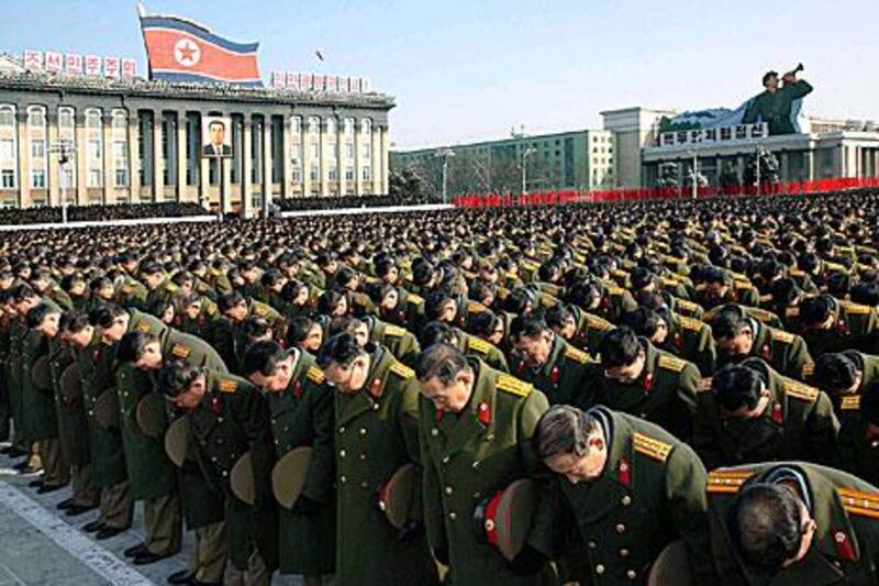 Military personnel observe a silent prayer over the late North Korea leader, Kim Jong-il, as his son, Kim Jong-un was declared 'Supreme Leader' today.