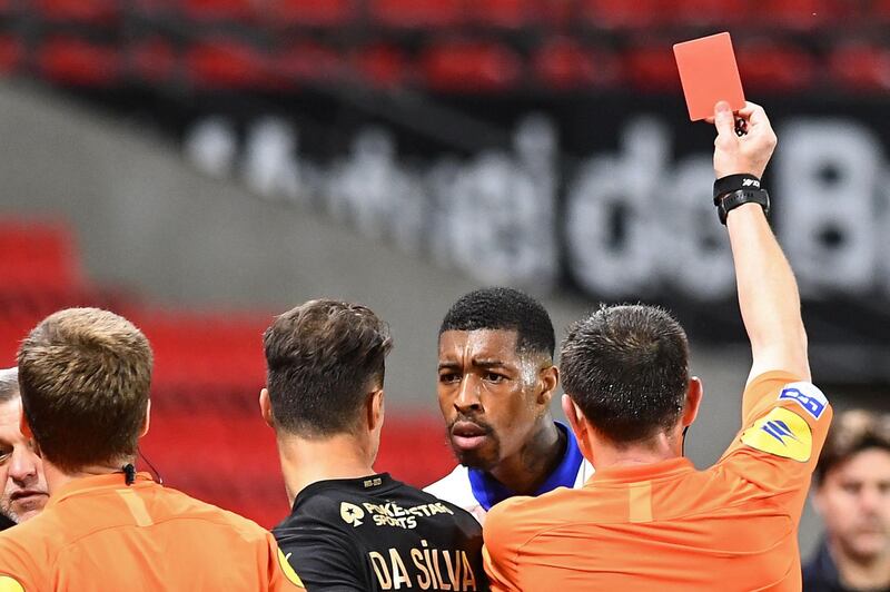 French referee Ruddy Buquet shows a red card to Paris Saint-Germain's French defender Presnel Kimpembe. AFP