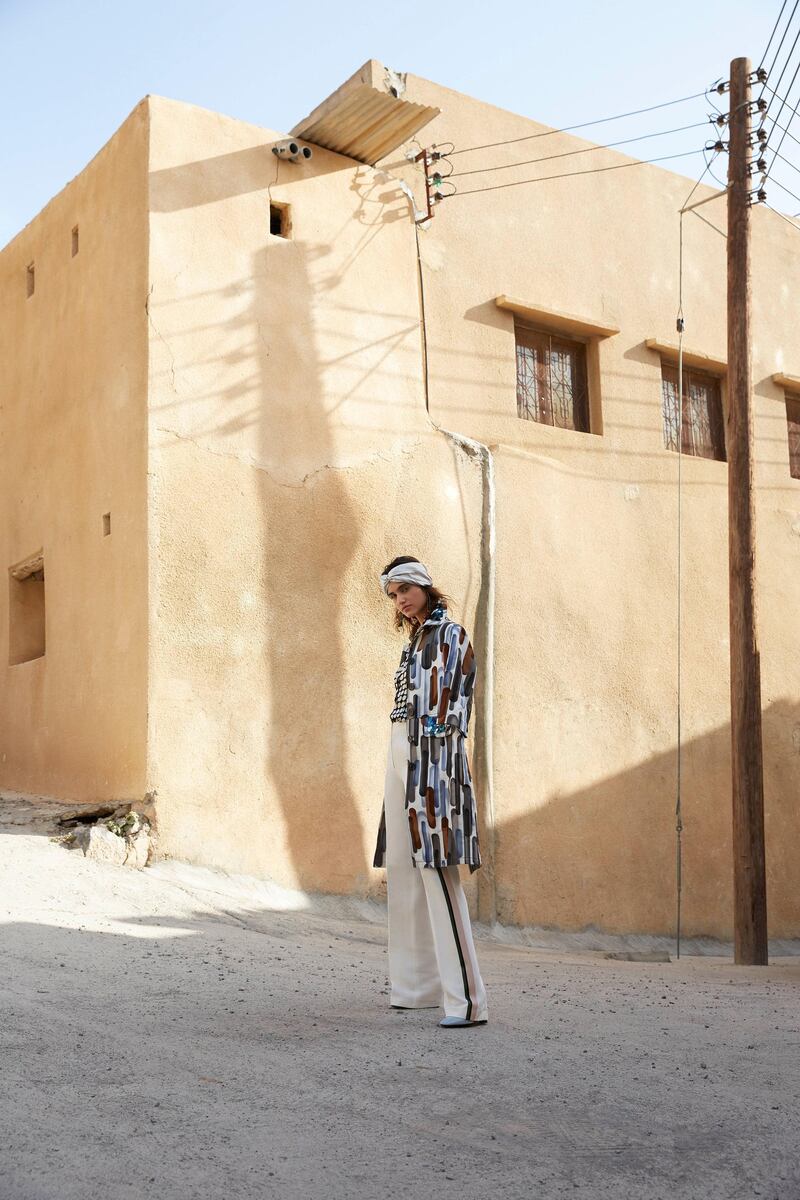 PASSAGE TO OMAN. Photography by Alex Trommlitz; Fashion director | Sarah Maisey

At a crossroads / flit across / 
Light and shadow
Coat, Dh12,950; shoes, Dh2,450, both from Bottega Veneta. Trousers, Dh3,100, Kristina Fidelskaya. Blouse, Dh3,039, Edeltrud Hofmann at Matches Fashion. Turban, Dh496, Eugenia Kim 