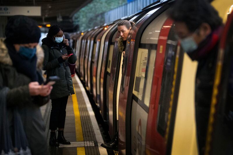 Commuters getting on a Jubilee Line Underground train at Canning Town station in London. AP Photo