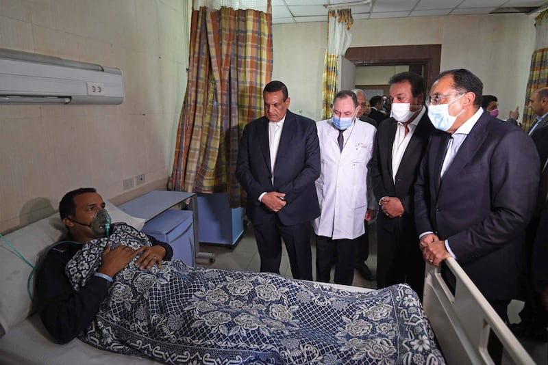 The prime minister visits one of the 14 people in hospital after the blaze. AFP