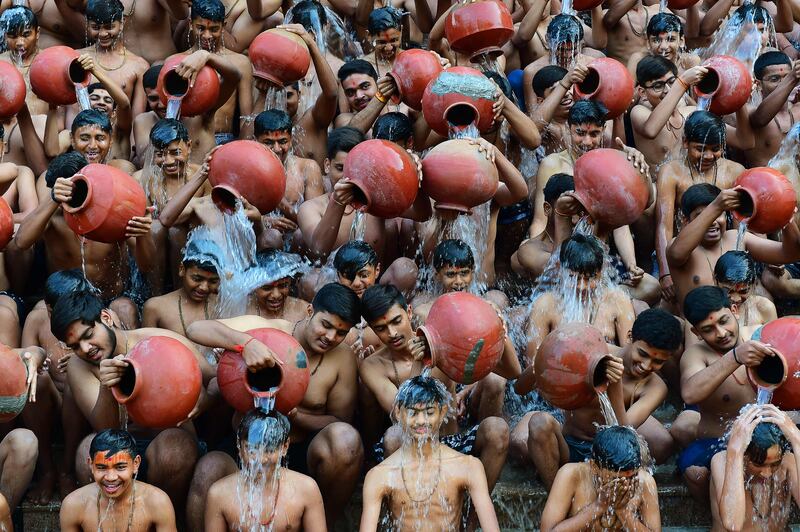 Students from the Swaminarayan Gurukul school take part in a Magh Snan, or holy bath, in Ahmedabad, western India. AFP