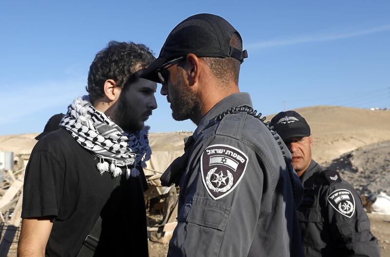 A demonstrator is face to face with an Israeli soldier during a protest against Israel's plan to demolish the Palestinian Bedouin village of Khan Al Ahmar in the West Bank. EPA