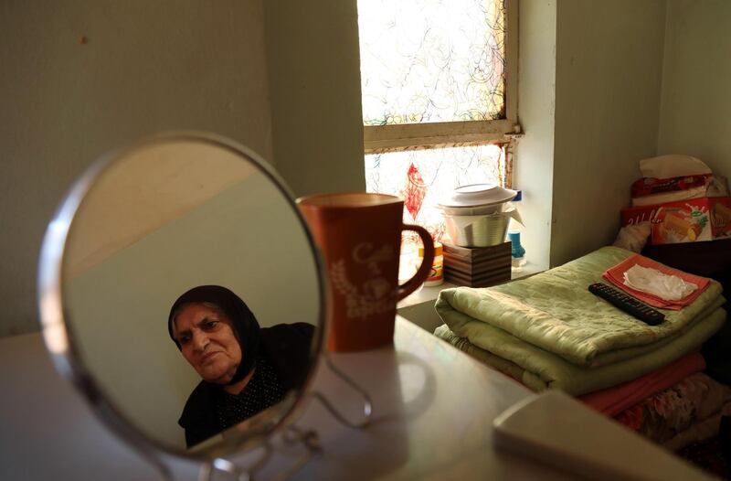 A woman reflected in a mirror sits in a house run by an NGO that take care of abandoned people by their families, in Erbil, Iraq. AFP