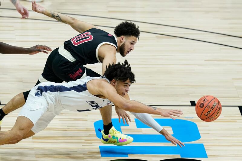 Nebraska's Kobe Webster, top, and Penn State's Seth Lundy dive for the ball during the first half of an NCAA college basketball game at the Big Ten men's tournament, in Indianapolis. AP Photo