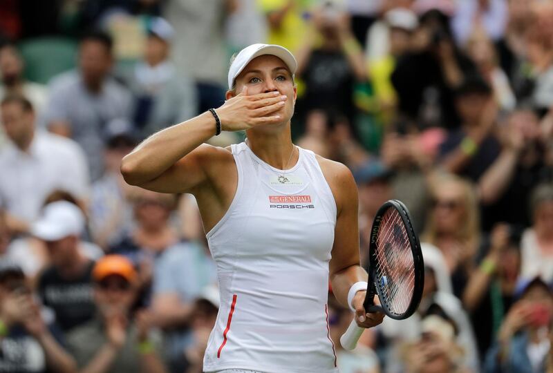 Germany's Angelique Kerber celebrates after beating Germany's Tatjana Maria in a Women's singles match during day two of the Wimbledon Tennis Championships in London, Tuesday, July 2, 2019. (AP Photo/Ben Curtis)
