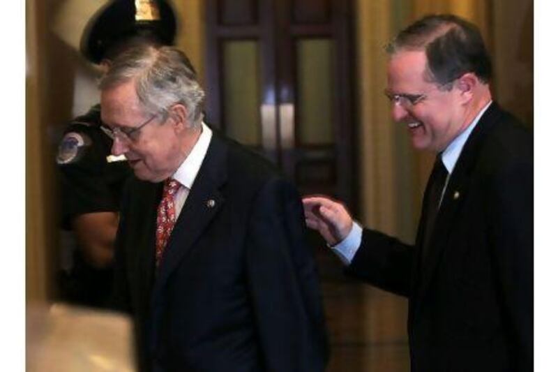 Senator Harry Reid, (left), followed by Senator Mark Pryor, after a Senate session on Saturday. Alex Wong / Getty Images / AFP