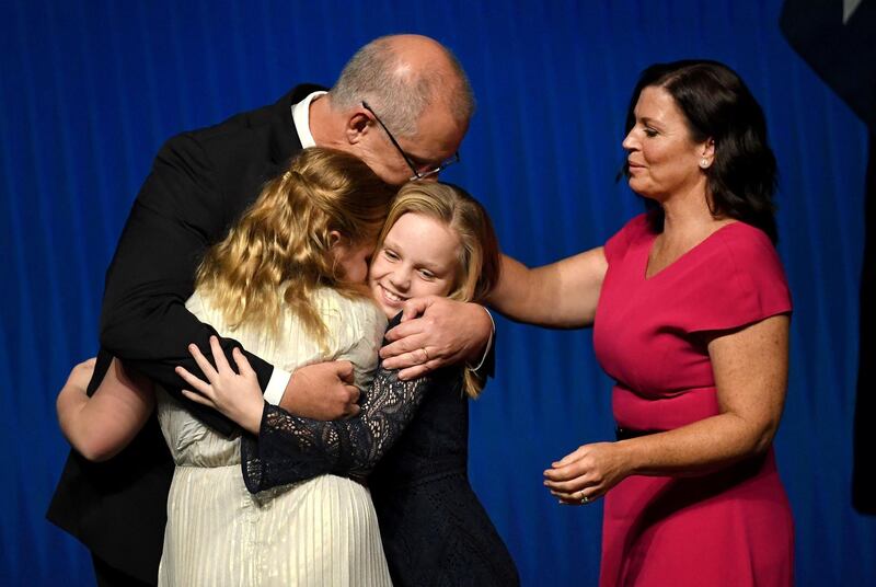 Australia's Prime Minister Scott Morrison hugs his daughters Abbey and Lily with wife Jenny Morrison after the Liberal Party's campaign launch in Melbourne. AFP