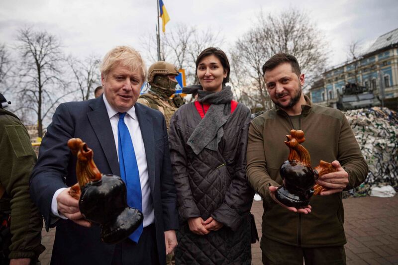 The leaders pose for a picture with a woman, after she gave them gifts. AP