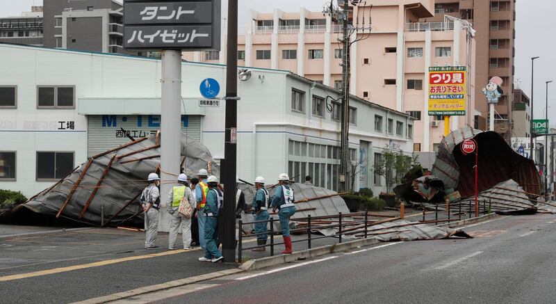 The roofs of a car factory are seen on sidewalk after typhoon hit Fukuoka, southwestern Japan. AP