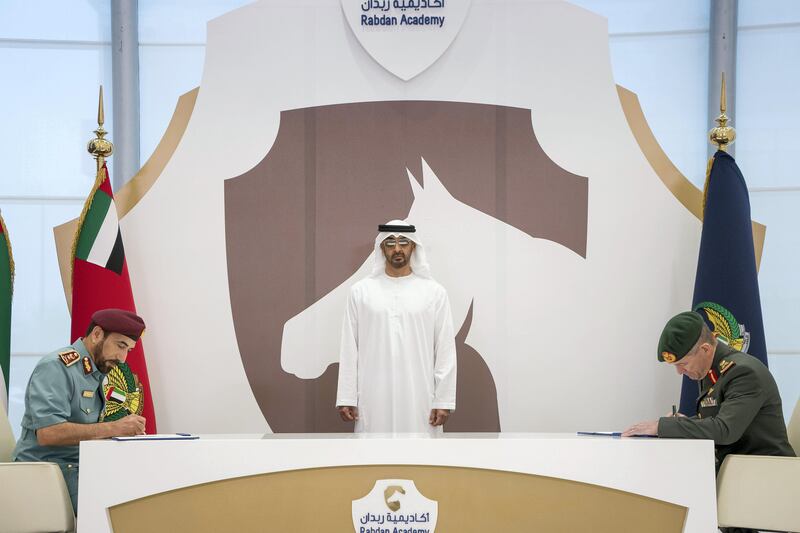 ABU DHABI, UNITED ARAB EMIRATES -September 20, 2017: HH Sheikh Mohamed bin Zayed Al Nahyan, Crown Prince of Abu Dhabi and Deputy Supreme Commander of the UAE Armed Forces (C), witnesses a MOU between UAE Minister of Interior and Rabdan Academy, signing on behalf UAE Minister of Interior, HE Lt General Saif Abdullah Al Shafar Undersecretary of the UAE Ministry of Interior (L) and on behalf Rabdan Academy, Major General Mike Hindmarsh, Chairman of the Board of Trustees of the Rabdan Academy (R).

( Rashed Al Mansoori / Crown Prince Court - Abu Dhabi )
---